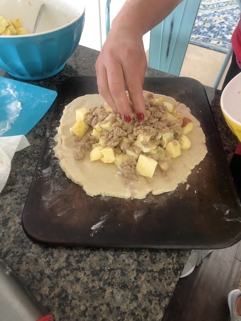 adding chopped apples and topping to the crostata dough