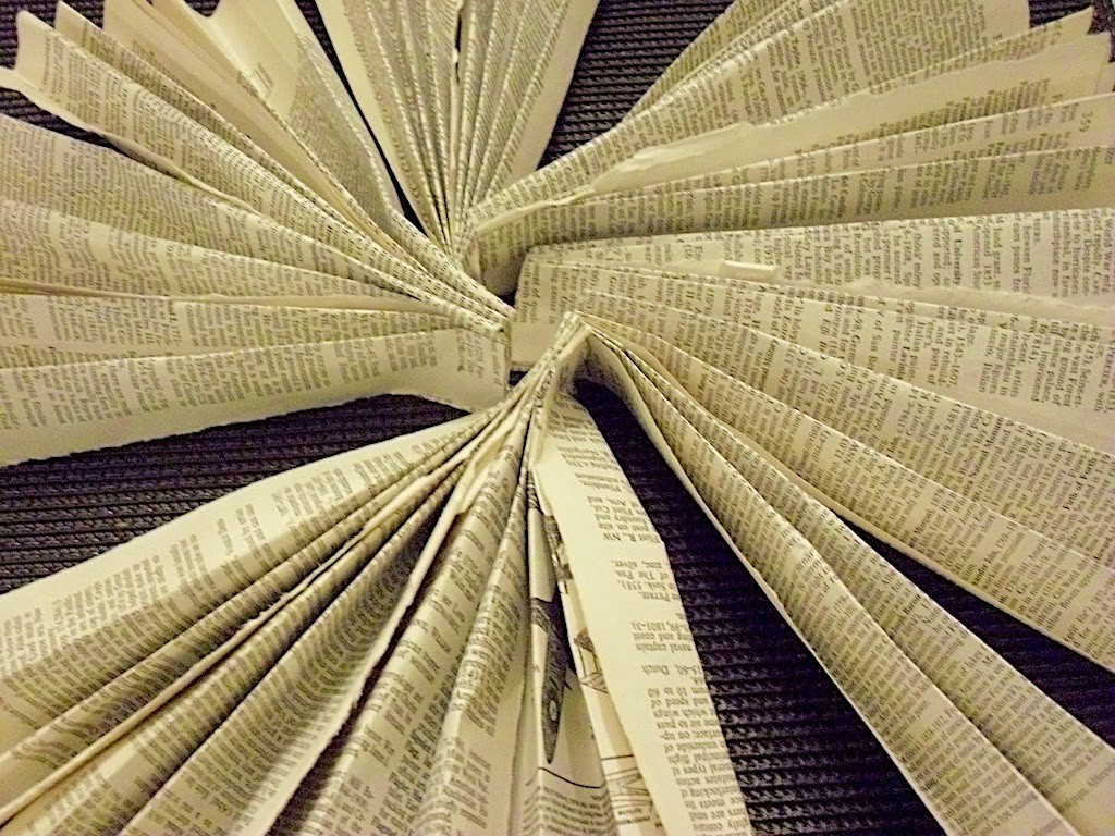 folded book pages to create a charger plate