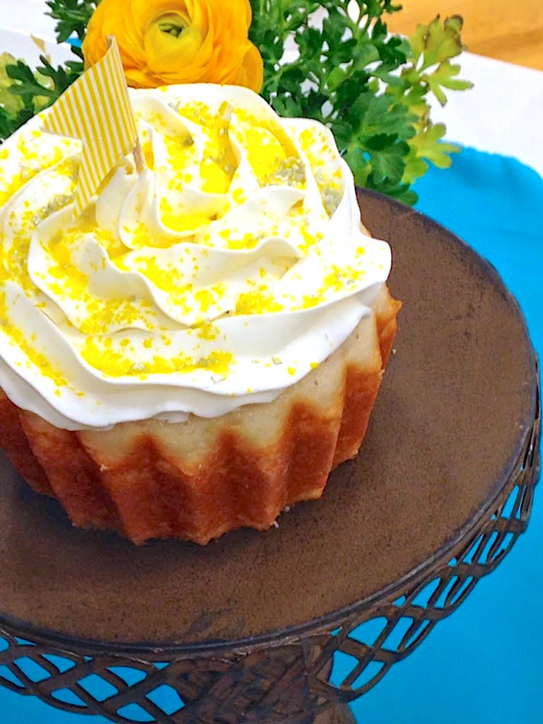 Cake stand with large cupcake on dessert table