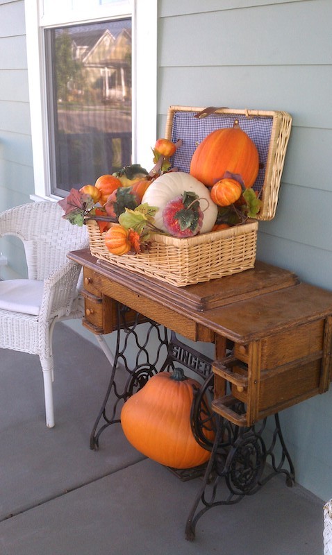 Fall porch with old sewing machine cabinet