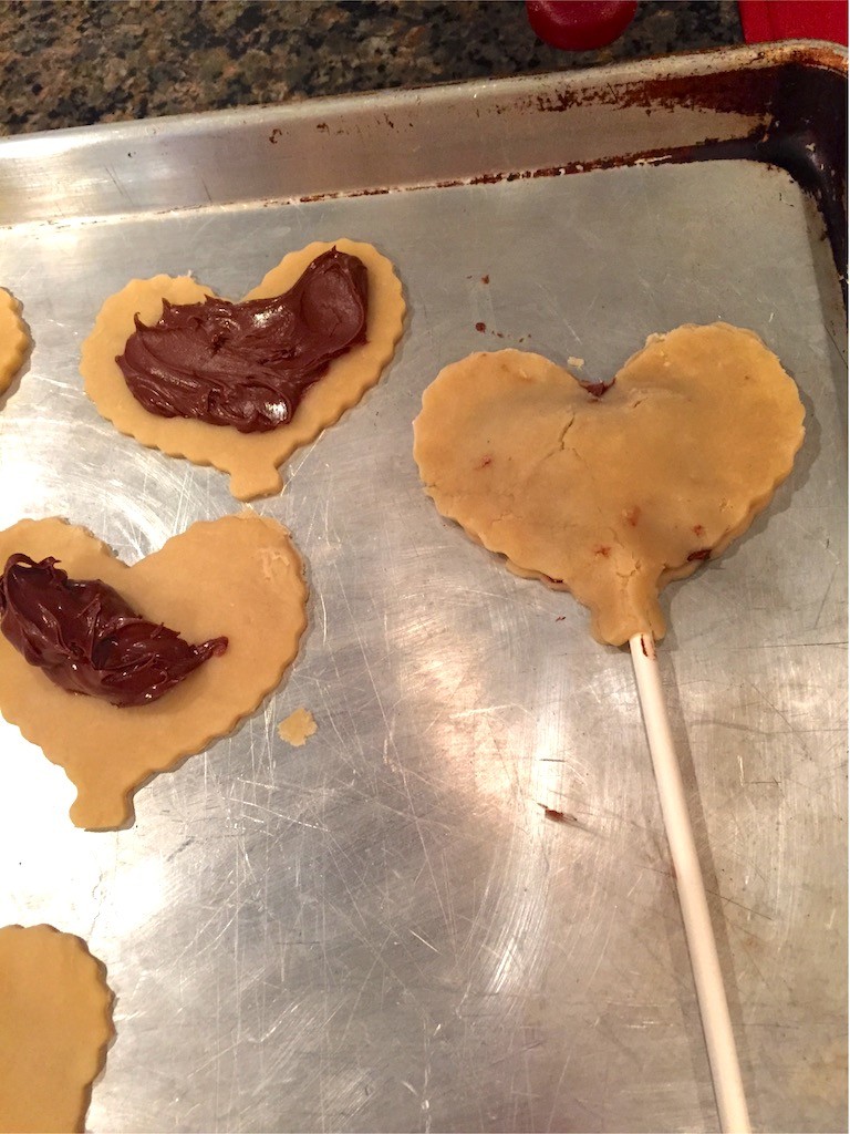 Place stick into heart shaped pie crust