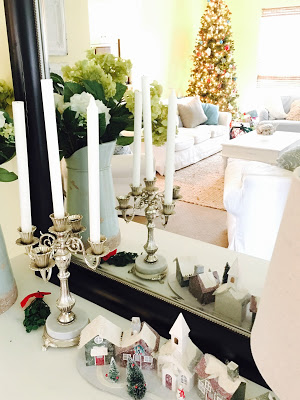View of family room decorated  for Christmas through mirror