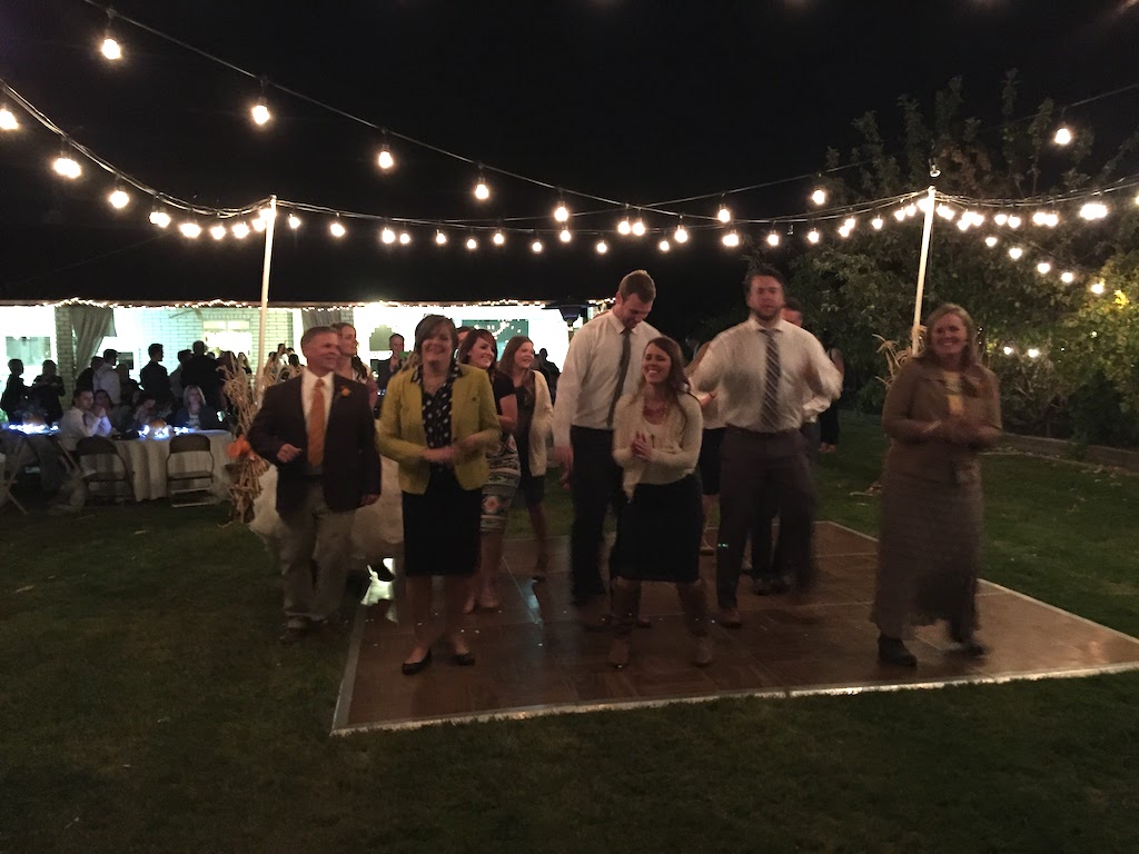 Everyone dancing at the easy outdoor wedding reception