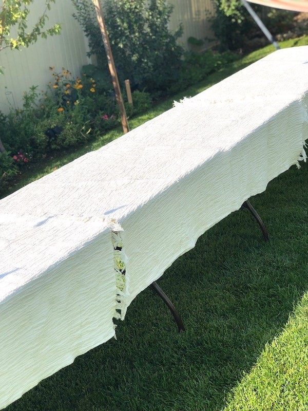 Tablecloth on two outdoor tables for summer dinner party