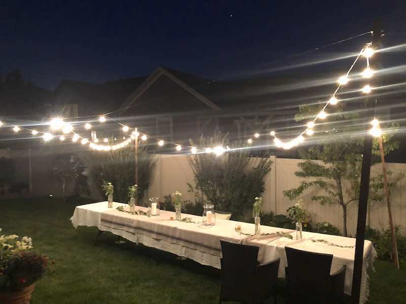 Hanging lights to host outdoor summer dinner party