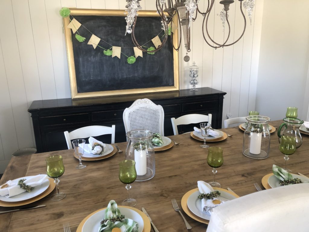 Green and gold tablescape with large chalkboard