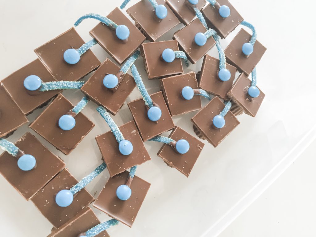 Graduation cap candies for cupcakes. Made from mini Reese's peanut butter cups, Hershey's chocolate bar, mini m&m's and Air head candy