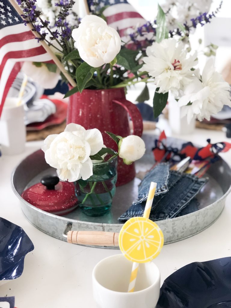4th of July red white and blue tablescape with yellow striped straws
sitting on galvanized tray