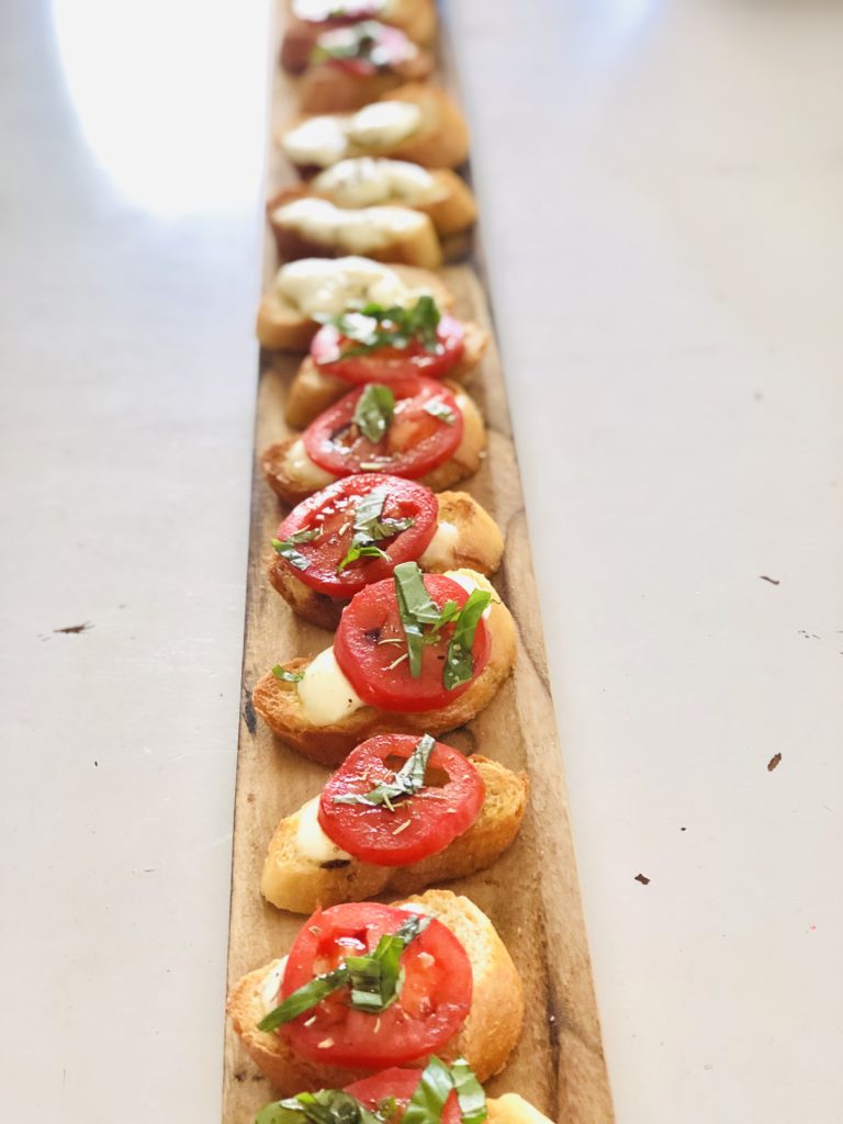 tomato bruschetta that is easy to make served on a wooden board