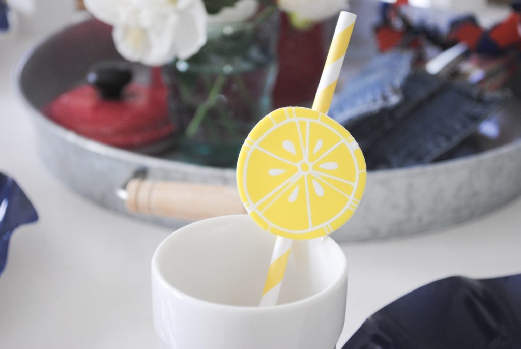 yellow and white striped paper straw with lemon slice decoration