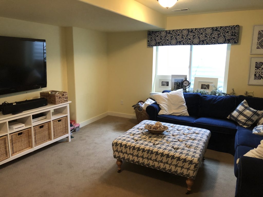 Before basement makeover- Yellow walls in basement. 