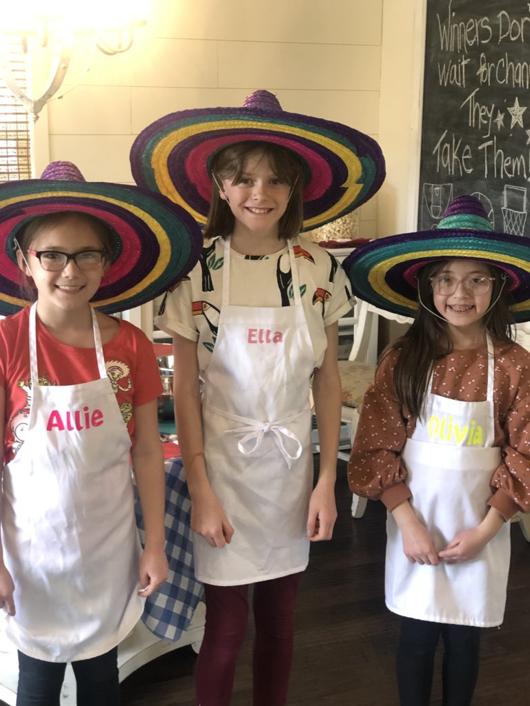 3 amigos at kids cooking class learning to cook tacos.