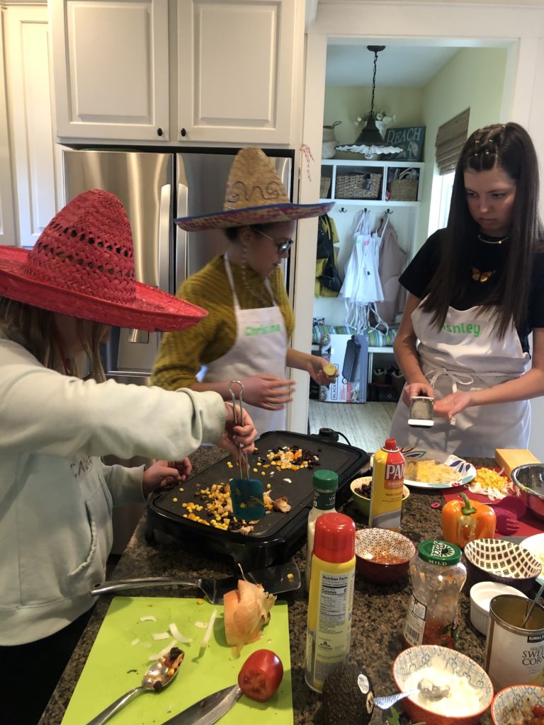 Teen girls learning how to make tacos 