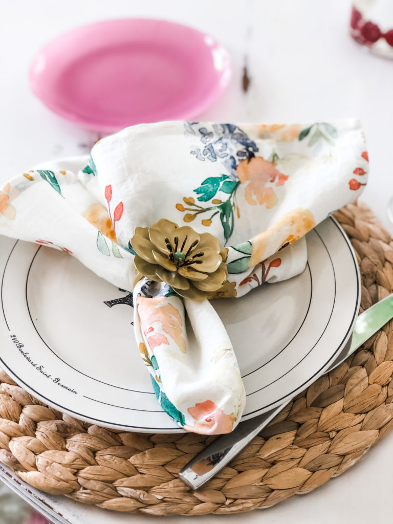 pretty floral napkins cinched with a flower napkin ring