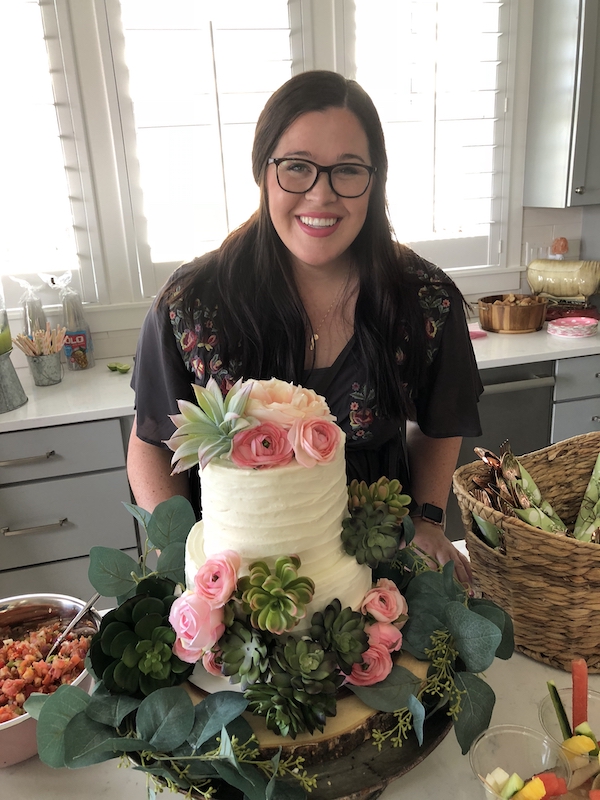 Fiesta baby shower taco Salad bar. Beautiful mother to be standing by her cake covered in succulents and flowers. 