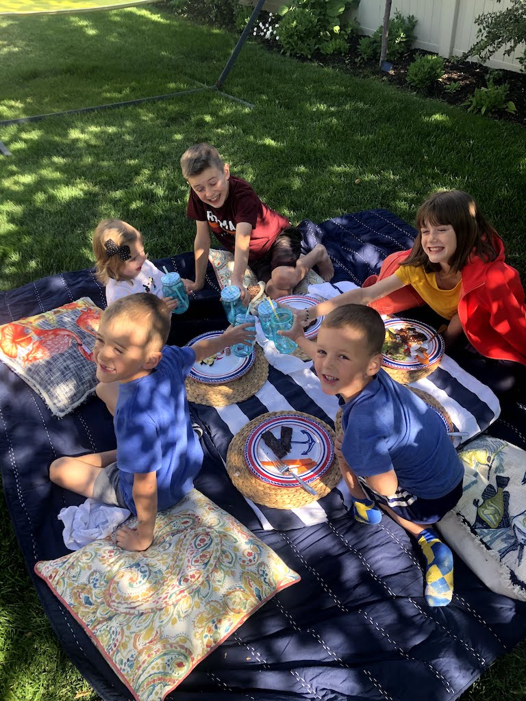 dinner under our backyard tree with grandkids