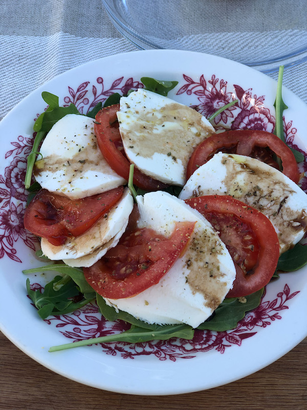 Easy caprese salad for an outside dinner for two. Dinner party. Summer dining in the backyard. 