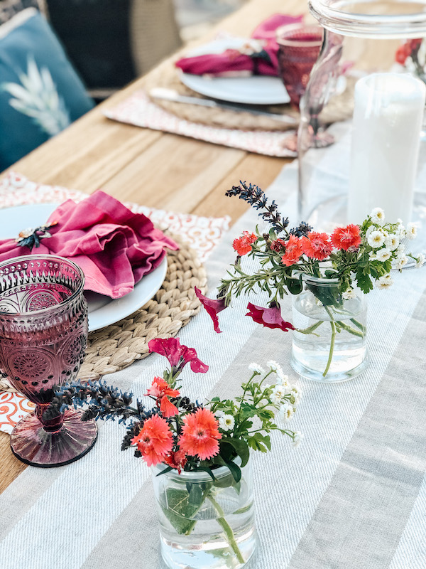 Outdoor dining for two tablescape using plum colored goblets, flowers from backyard