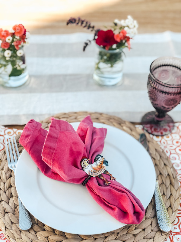 outdoor Tablescape- Placesetting white plate, Pink napkin, rooster napkin ring dinner for two