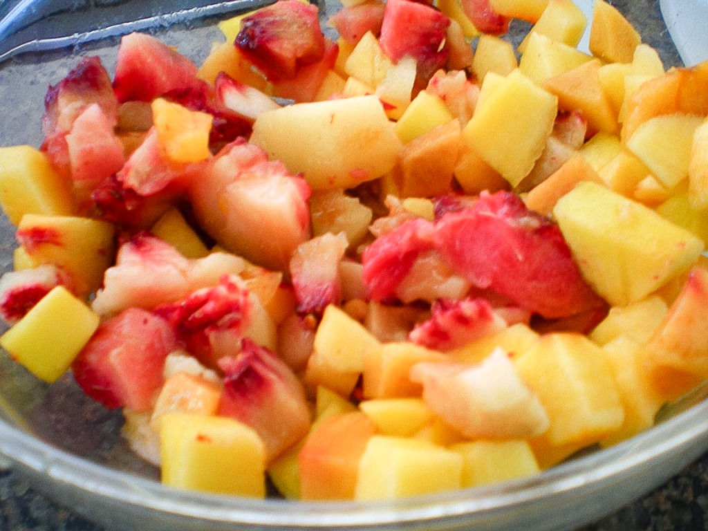 cut up peaches for mini peach and raspberry pies