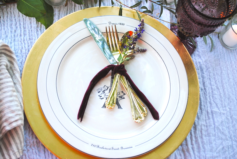 Romantic outdoor dinner at home- Karins Kottage
 place settings using gold chargers, gold flatware tied with velvet ribbon