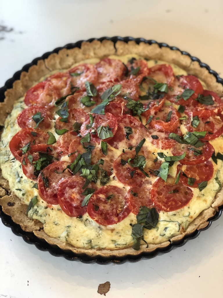 Tomato ricotta basil tart that is super easy to make. Use up those tomatoes and basil from your summer garden. The crust is made with flour, olive oil and toasted pine nuts. 