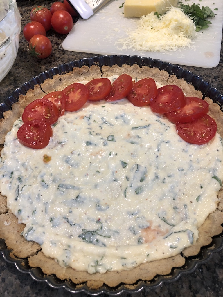 tomato ricotta basil tart with filling and sliced tomatoes