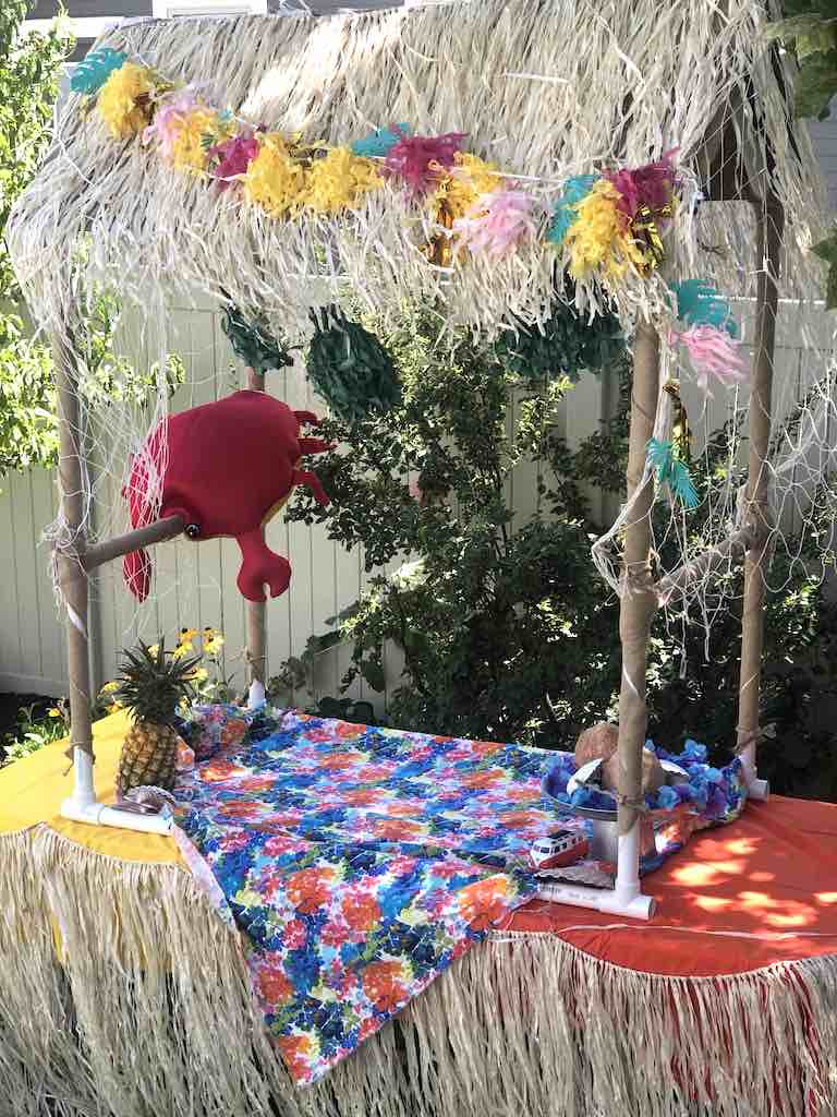 decorating tiki bar with colorful fabric, crab pillow and other decor