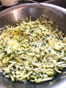 How to shred the zucchini for the zucchini lemon ricotta galette.