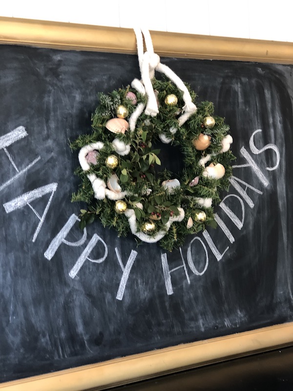 Hanging Coastal Christmas wreath on Chalkboard
