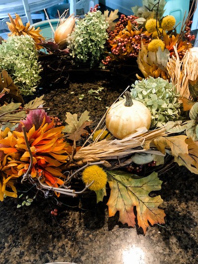 Adding hydrangeas and pumpkins to  wreath