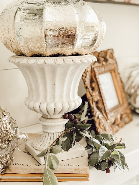 Creamy white urn with silver pumpkin on top