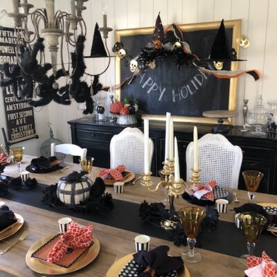 Halloween tablescape with spiders and witch hats