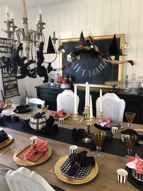 Halloween tablescape with spiders and witch hats