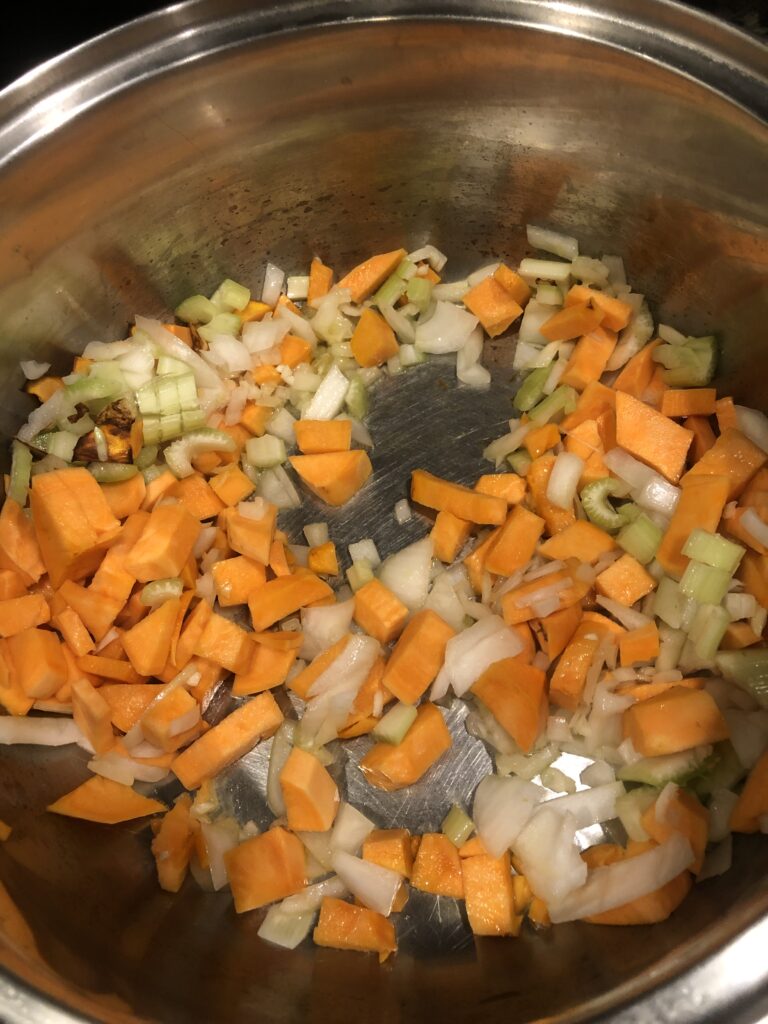 Sauteing yams, onions, celery and garlic.