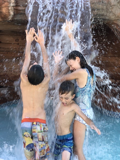 Kids in waterfall in moab Utah