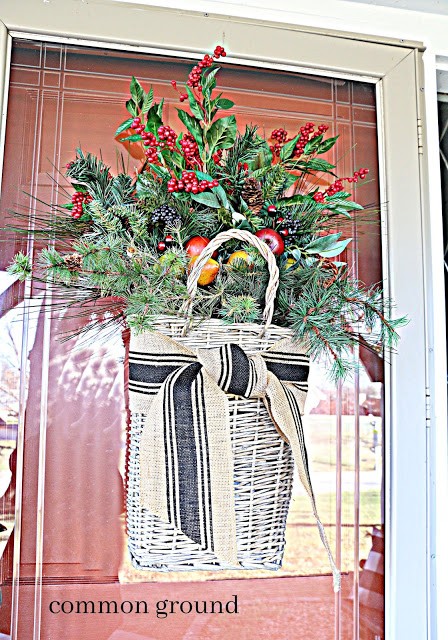 Greenery in basket on red door 