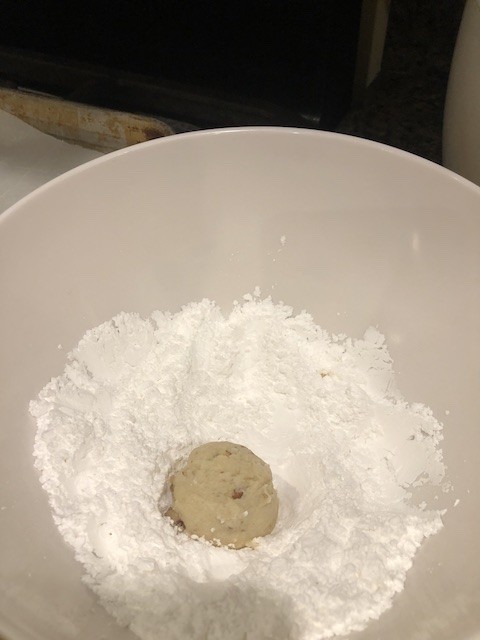 Roll the snow ball cookie in powder sugar