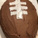 Yellow football cake with nutella frosting
