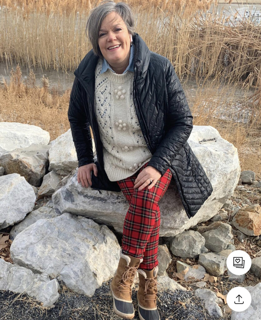 Big beige sweater over red tartan pants