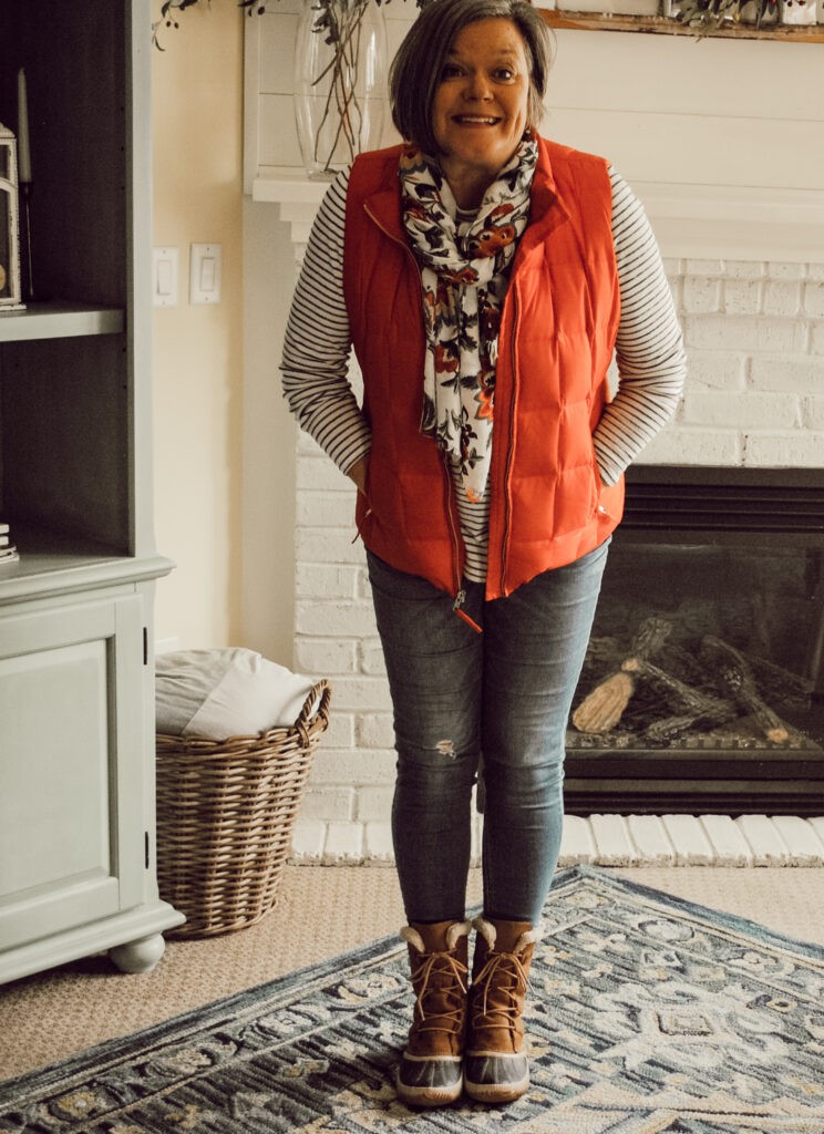 red vest with striped shirt and jeans