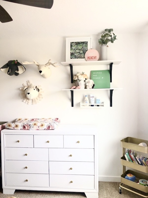 Cute nursery for a new grand baby - white dresser, shelving, gold storage 