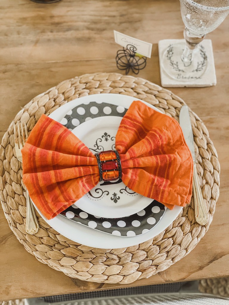 orange napkin folded into a bow 