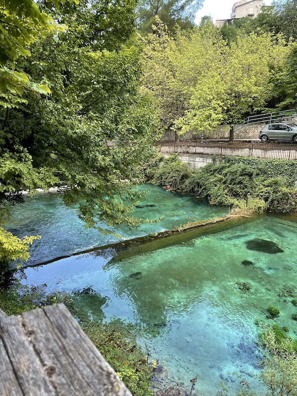 aqua colored water at the base of italian hiking in canyon