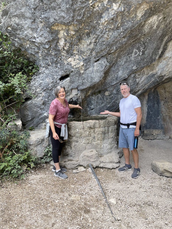 Hiking in an Italian canyon seeing water falling. 