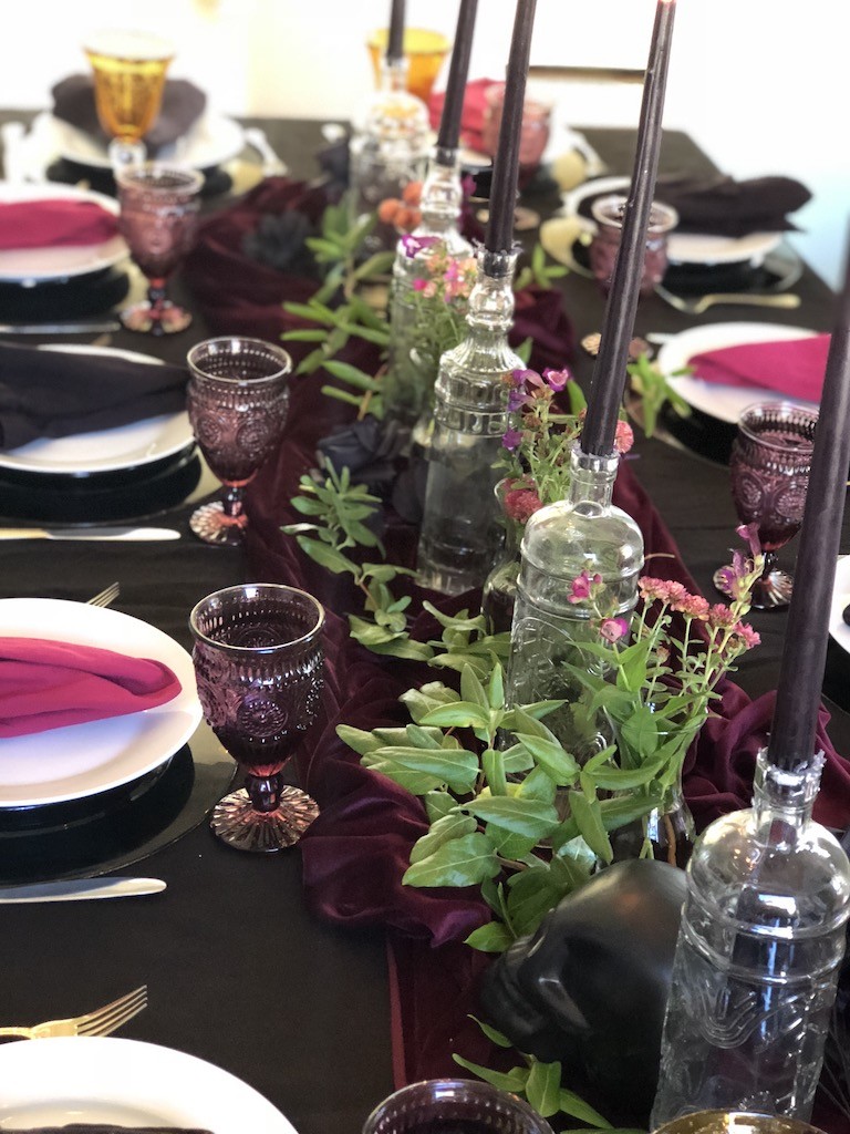 black tapered candles in dollar store vases create moody Halloween look