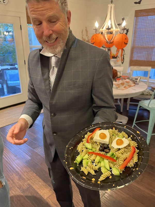 Adults making pasta with pesto monster faces- Karins Kottage