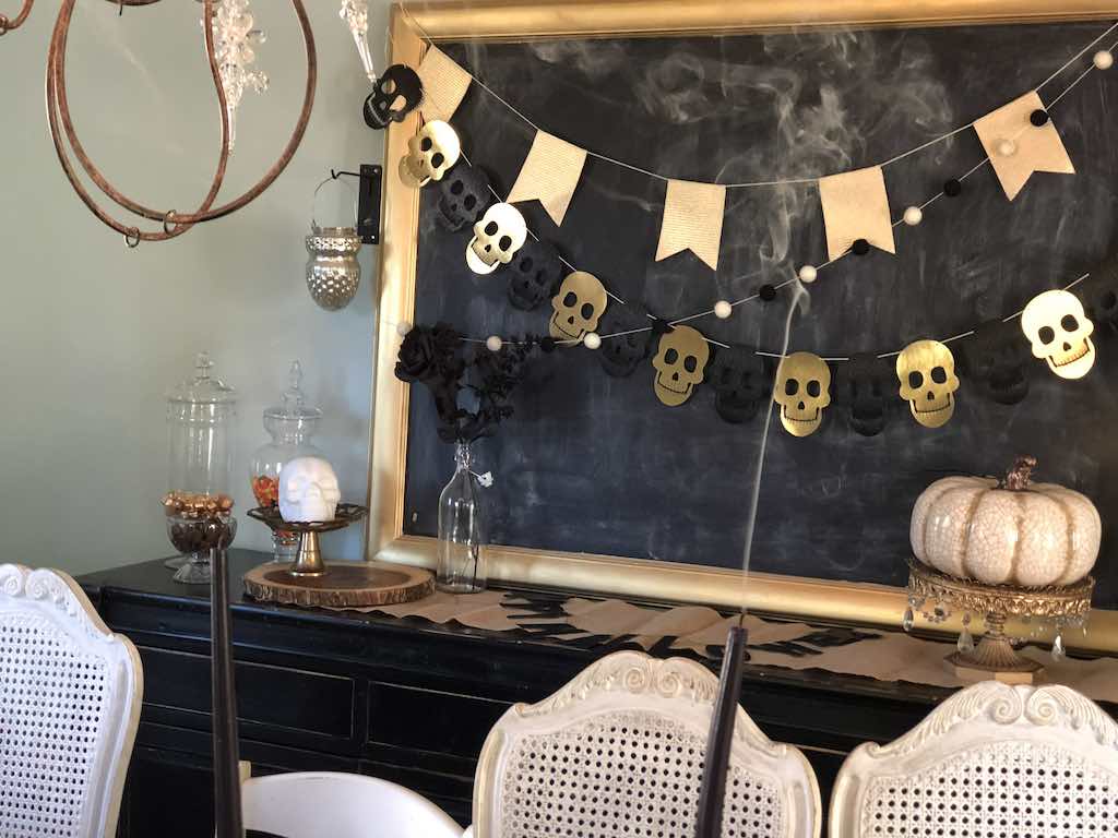Gold and black skull garland on large chalkboard for moody Halloween dining room- Karins Kottage 
