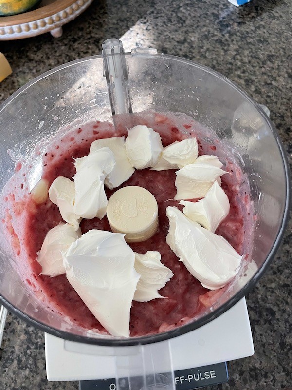 adding cream cheese to cranberry sauce