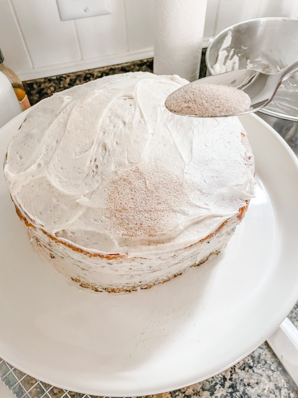 sprinkling cinnamon and sugar Simple Fall Banana Cake With Cream Cheese frosting 